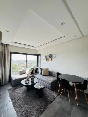 a living room with a couch and a table at Charming Apartment With City View in Casablanca