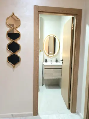 a bathroom with a mirror and a sink at Cozy studio with great pool views in Aïn Harrouda