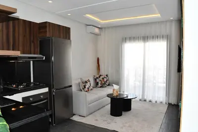 a living room with a couch and a table at Elegant Apartment with City View in Casablanca