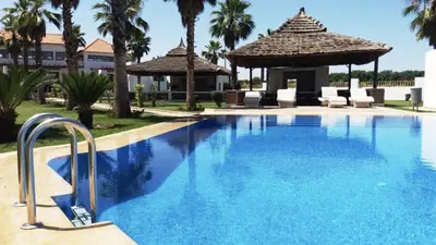 a large swimming pool with a gazebo at Jumeirah in Sidi Rahal