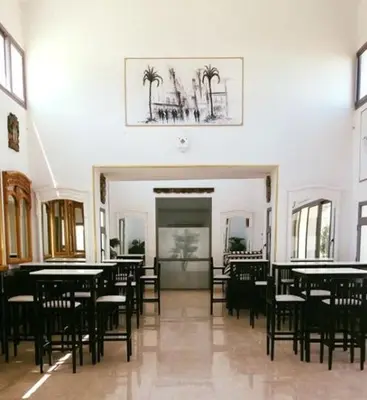 a dining room with tables and chairs and a picture on the wall at Jumeirah in Sidi Rahal