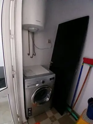 a refrigerator with a washing machine in a room at Appartement BAHIA BEACH piscine plage privée in Bouznika