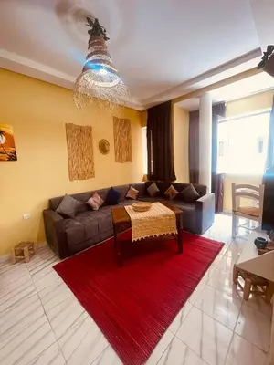 a living room with a couch and a red rug at Sduisant Studio in Casablanca in Casablanca