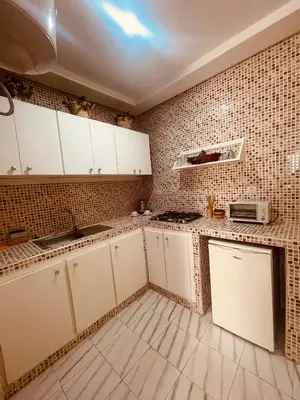a kitchen with white cabinets and a microwave at Sduisant Studio in Casablanca in Casablanca