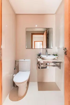 a bathroom with a toilet and a sink at L'Eden - 2 BR - Beachfront & Pool - 3 beds in Tamaris