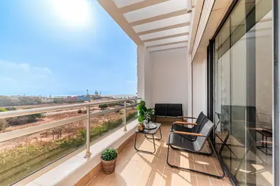 a balcony with chairs and a view of the ocean at L'Eden - 2 BR - Beachfront & Pool - 3 beds in Tamaris