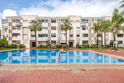 an apartment building with a swimming pool in front of it at Apartment with sea view in Mohammedia