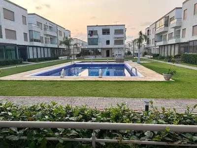 a swimming pool in front of some apartment buildings at Puerto Banus Appartement A4 in Mohammedia