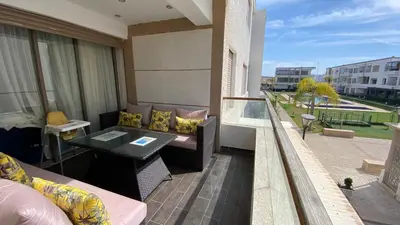 a balcony with a couch and a table on a balcony at Puerto Banus Appartement A4 in Mohammedia
