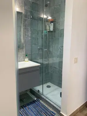 a bathroom with a shower with a sink and a toilet at Villa oasis sidi rahal in Casablanca