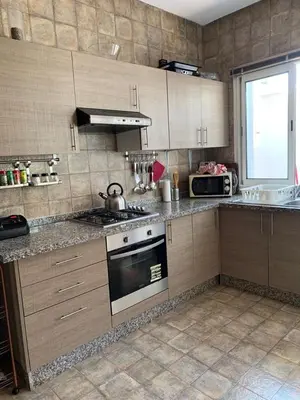 a kitchen with a stove and a sink in it at Villa oasis sidi rahal in Casablanca