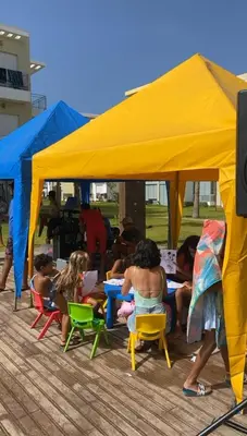 a group of people sitting under a yellow tent at CASABAY KETTANI SIDI Rahal in Sidi Rahal