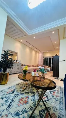 a living room with two tables and a couch at CASABAY KETTANI SIDI Rahal in Sidi Rahal