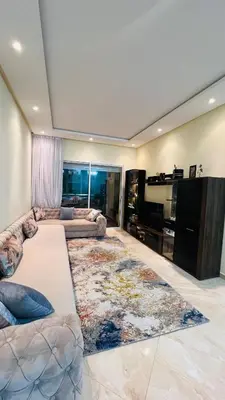 a living room with a couch and a large rug at CASABAY KETTANI SIDI Rahal in Sidi Rahal