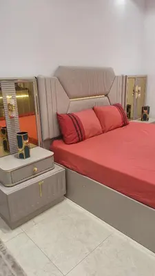 a bedroom with a bed with red pillows on it at Étage d'une prestigieuse villa in Rabat