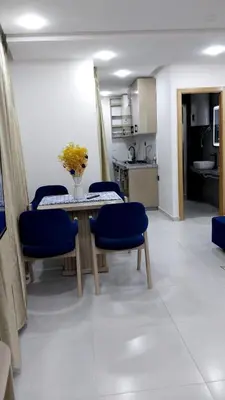 a dining room with a table and blue chairs at Studio Chefchaoun in Deroua