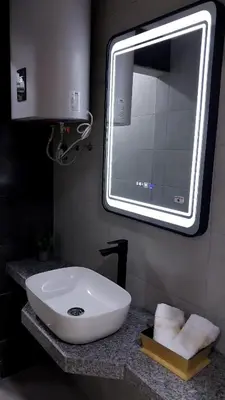 a bathroom with a white sink and a mirror at Studio Chefchaoun in Deroua
