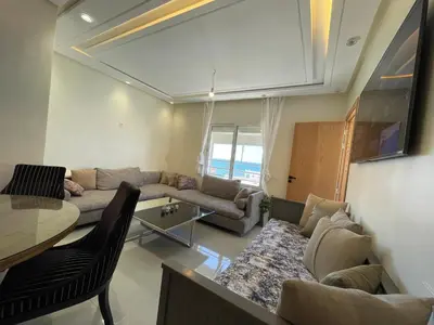 a living room with a couch and a table at Cosy Studio Sea View in Casablanca in Tamaris
