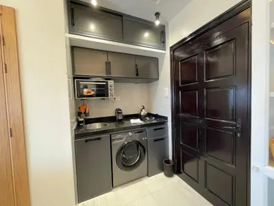 a small kitchen with a washing machine and a sink at Cosy Studio Sea View in Casablanca in Tamaris