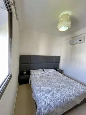 a bedroom with a bed and a large window at Appartement Blanca Beach lumineux avec balcon in Sidi Rahal