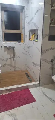 a bathroom with a shower with a television in it at Luxe Suite au sein d'une villa in Rabat