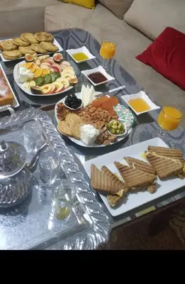 a table with many plates of food on it at Luxe Suite au sein d'une villa in Rabat