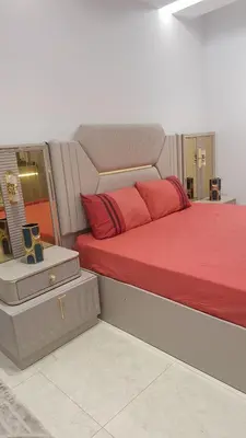 a large bed with red pillows in a room at Luxe Suite au sein d'une villa in Rabat