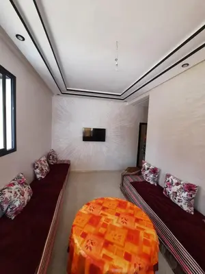 a living room with two couches and a bed at Bouznika mandarona in Bouznika