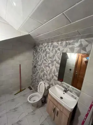 a bathroom with a toilet and a sink at Bouznika mandarona in Bouznika