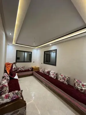a living room with couches and pillows at Bouznika mandarona in Bouznika