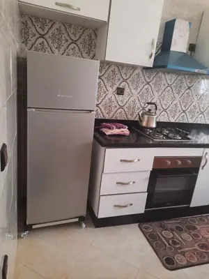 a kitchen with a refrigerator and a stove at Bouznika mandarona in Bouznika