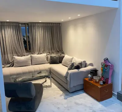a living room with a couch and a table at Le LOFT in Casablanca