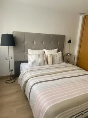a large bed with a large headboard in a bedroom at Le LOFT in Casablanca