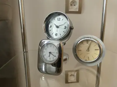 three clocks are hanging on a wall at Le LOFT in Casablanca