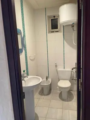 a bathroom with a toilet and a sink at Skhirat Beach Appartement in Skhirat