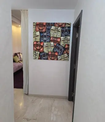 a painting hanging on a wall in a hallway at 2 Bedroom Apartment in Mohammedia