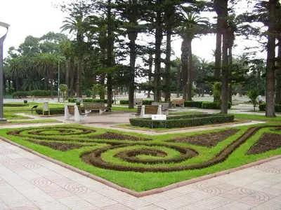 a park with a spiral garden with benches and trees at Suite Horizon in Mohammedia