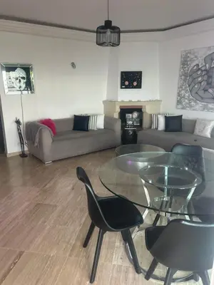 a living room with a glass table and a couch at twins in Casablanca