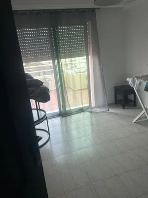 a living room with a chair and a window at twins in Casablanca