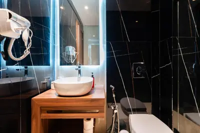 a bathroom with a sink and a mirror and a toilet at Résidence Cerezo in Maarif