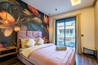 a bedroom with a large flower mural on the wall at Résidence Cerezo in Maarif