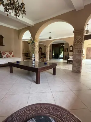 a large living room with a table in the middle at Chic home with a private pool in Dar Mouddene