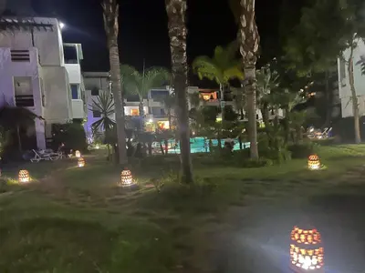 a house with lights in the yard at night at Ocean Symphony in Îlot de Skhirat
