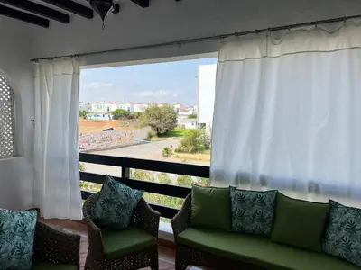 a living room with a couch and a large window at Ocean Symphony in Îlot de Skhirat