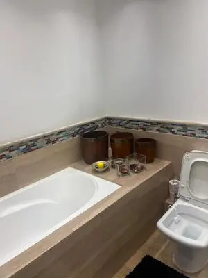 a bathroom with a large bath tub next to a toilet at Ocean Symphony in Îlot de Skhirat