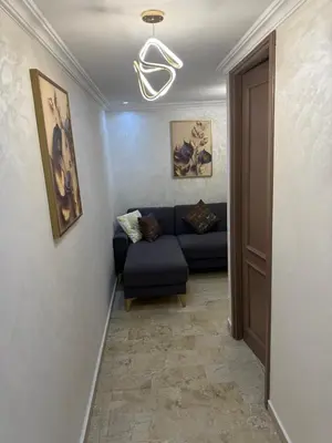 a living room with a blue couch in a hallway at Chic house living in Casablanca