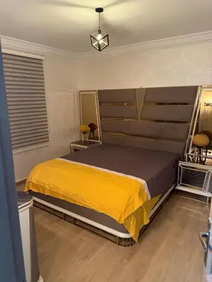 a bedroom with a large bed with a yellow blanket at Chic house living in Casablanca