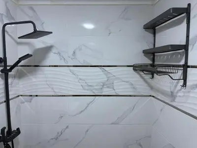 a bathroom with white marble walls and a mirror at Chic house living in Casablanca