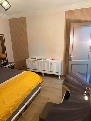a bedroom with a yellow bed and a table at Chic house living in Casablanca