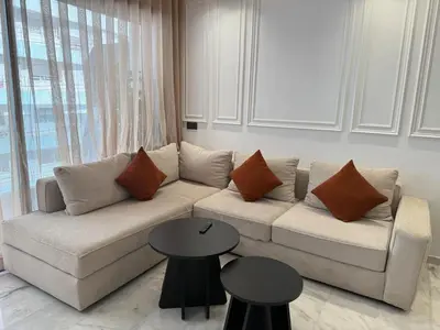 a living room with a couch and two tables at Stylish Apartment with a seaview 9 in Casablanca